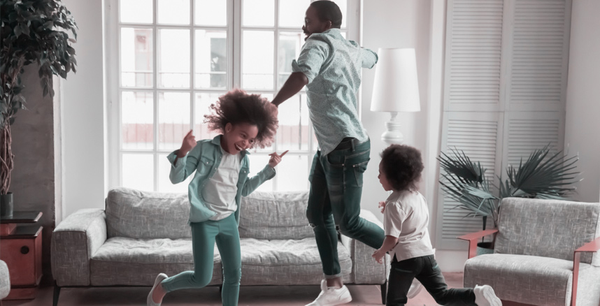 Dad and daughters dancing together